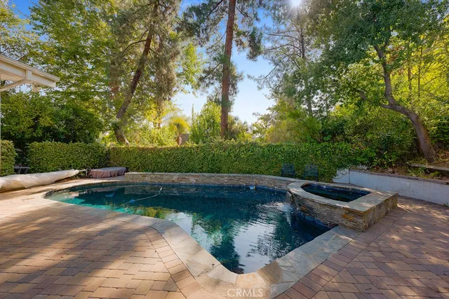 a view of a backyard with swimming pool