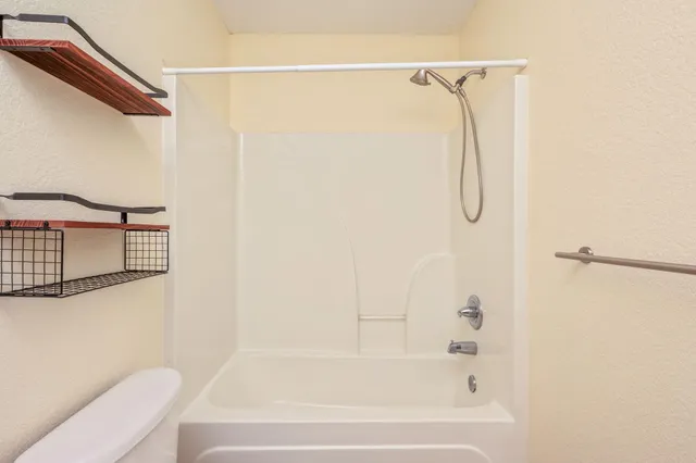 a bathroom with a shower and a bathtub