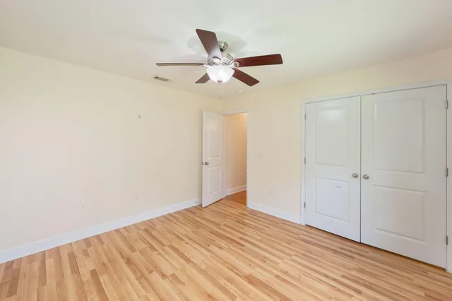 a view of a room with a ceiling fan
