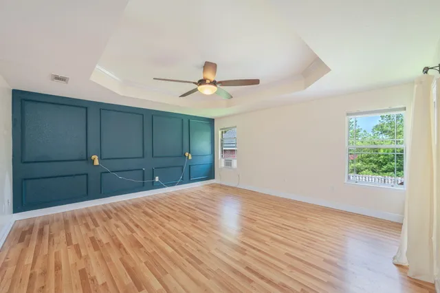 a view of a room with cabinet and a ceiling fan
