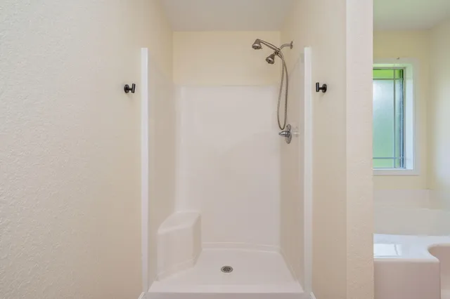 a bathroom with a glass shower door