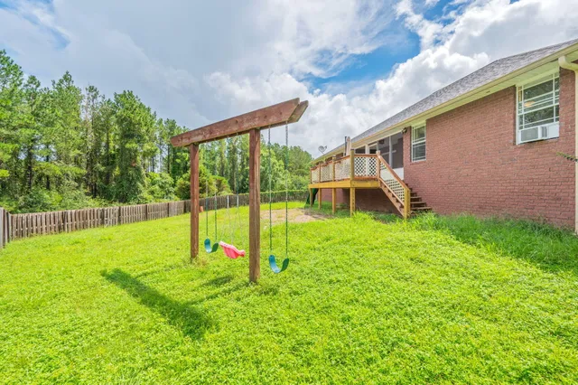 a view of a house with a backyard