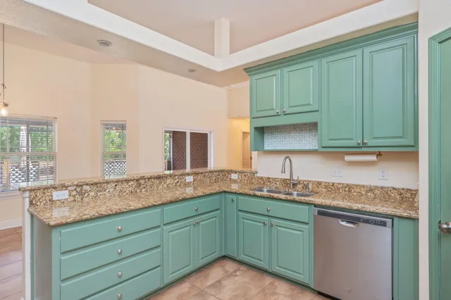 a kitchen with sink and cabinets
