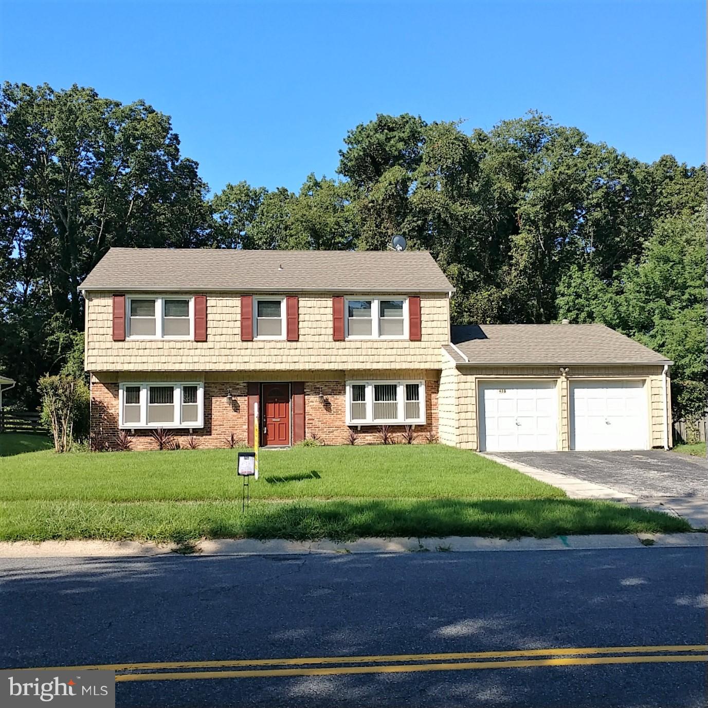 418 Haverhill Road Joppa, MD 21085 - Photo 1 of 28 a front view of a house with a garden and trees
