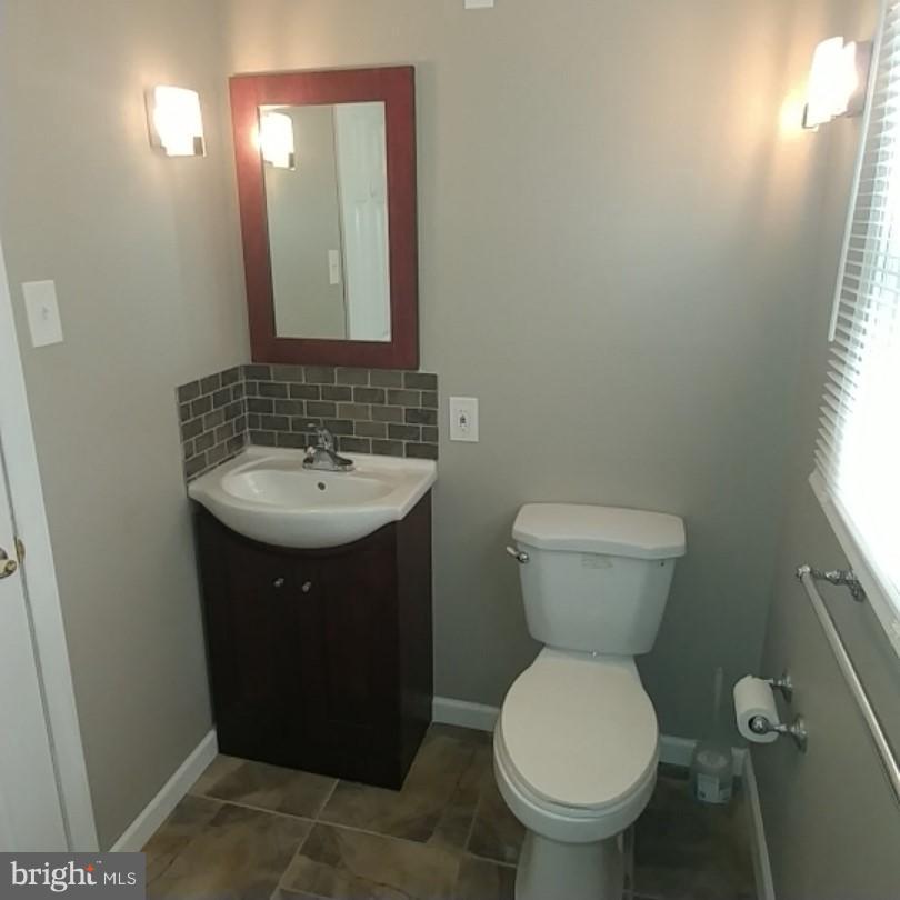 418 Haverhill Road Joppa, MD 21085 - Photo 24 of 28 a bathroom with a toilet sink and mirror