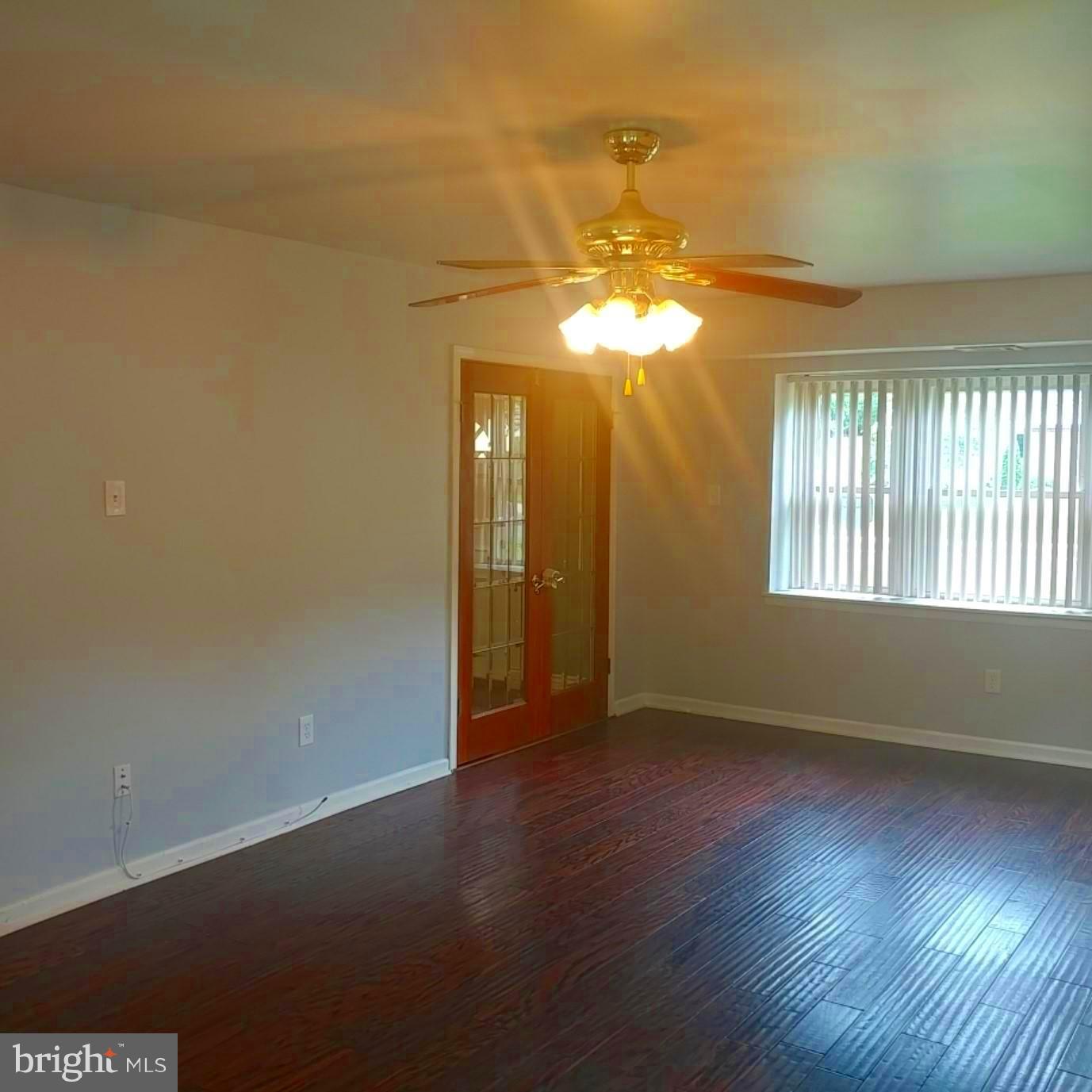 418 Haverhill Road Joppa, MD 21085 - Photo 4 of 28 an empty room with wooden floor and windows