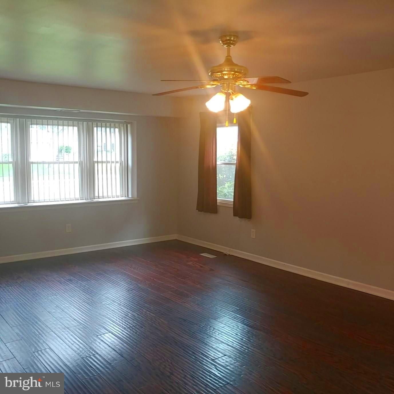 418 Haverhill Road Joppa, MD 21085 - Photo 5 of 28 an empty room with wooden floor and windows