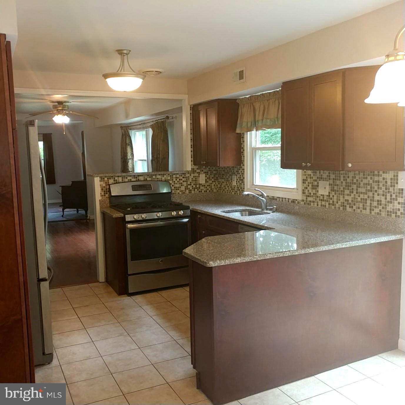 418 Haverhill Road Joppa, MD 21085 - Photo 9 of 28 a kitchen with a sink stove and cabinets