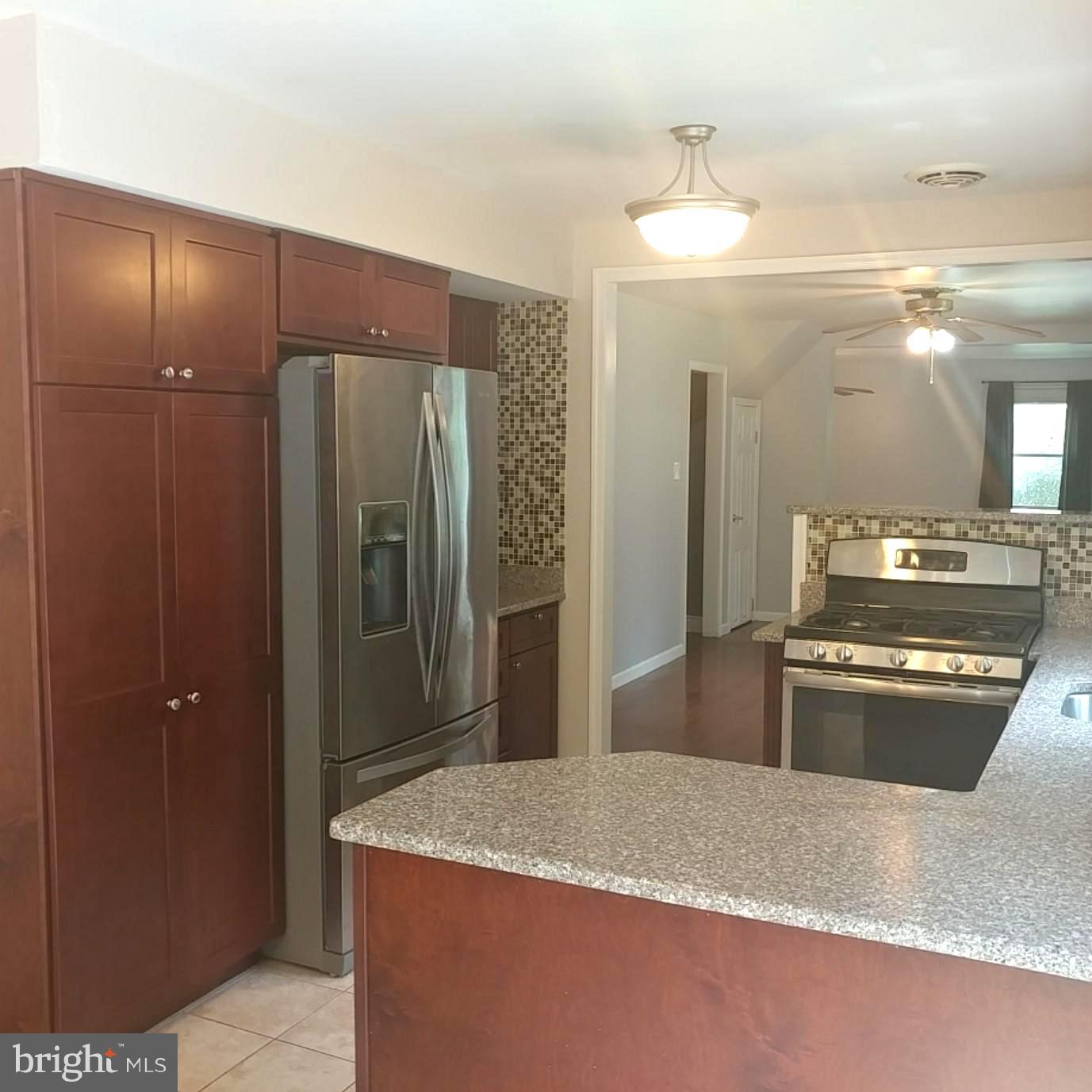 418 Haverhill Road Joppa, MD 21085 - Photo 10 of 28 a kitchen with stainless steel appliances granite countertop cabinets and refrigerator