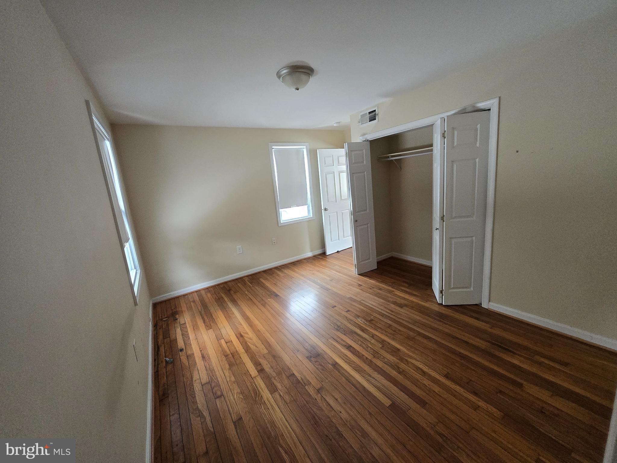 722 Church Hill Road Centreville, MD 21617 - Photo 3 of 7 a view of an empty room with wooden floor and window