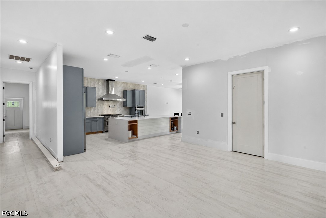 2665 Oil Well Road Naples, FL 34120 - Photo 7 of 40 a view of kitchen with stainless steel appliances kitchen island granite countertop a refrigerator and cabinets