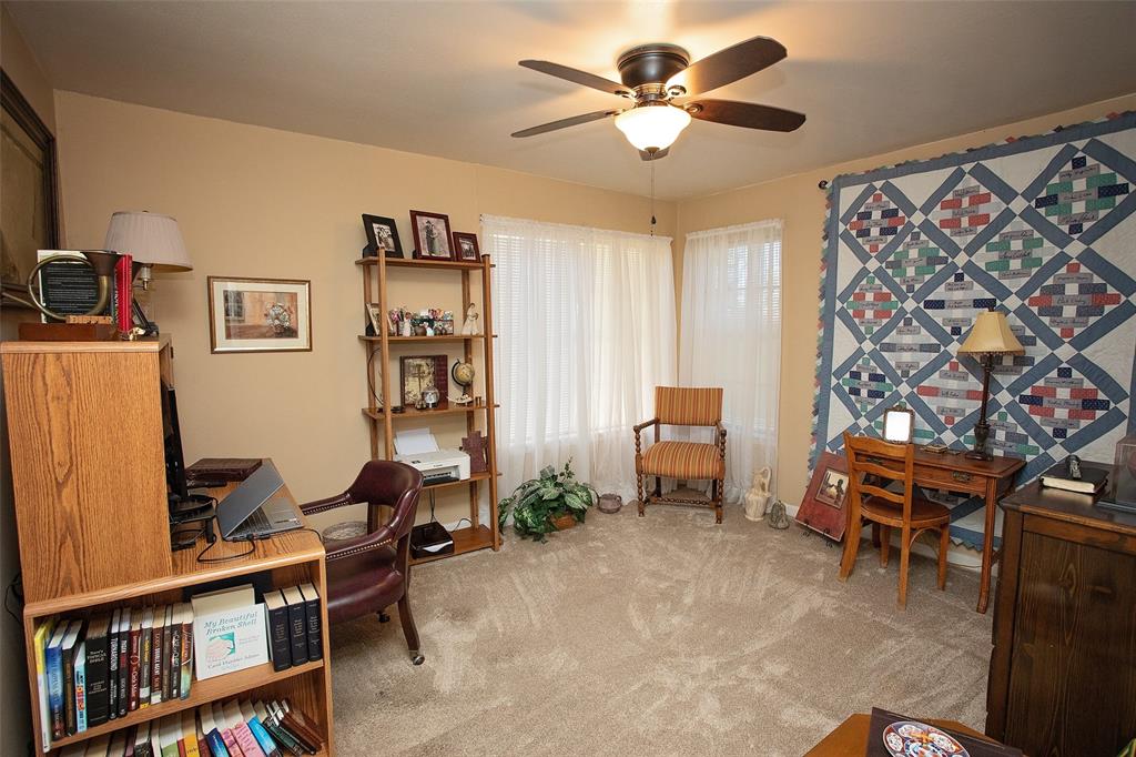914 Fairview Street Graham, TX 76450 - Photo 12 of 17 a living room with furniture and a bookshelf