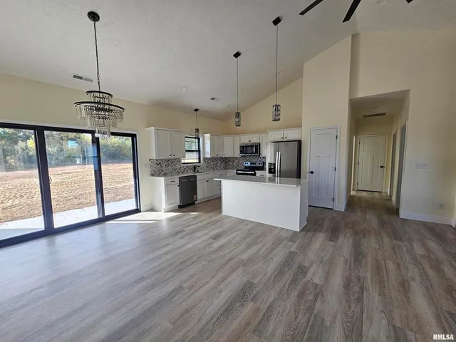 a view of a kitchen with a sink and wooden floor