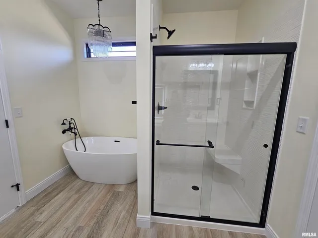 a bathroom with a bathtub and shower