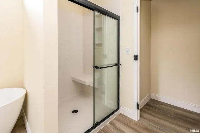 a bathroom with a glass shower door