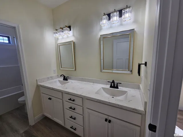 a bathroom with a double vanity sink and a mirror