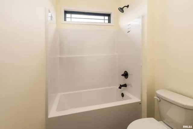 a bathroom with a bathtub and a toilet