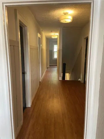 a view of a hallway with wooden floor
