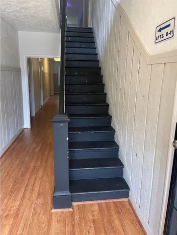 a view of entryway and gallery with wooden floor