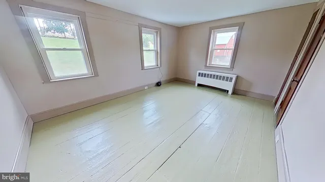 a spacious bedroom with a bed and a window