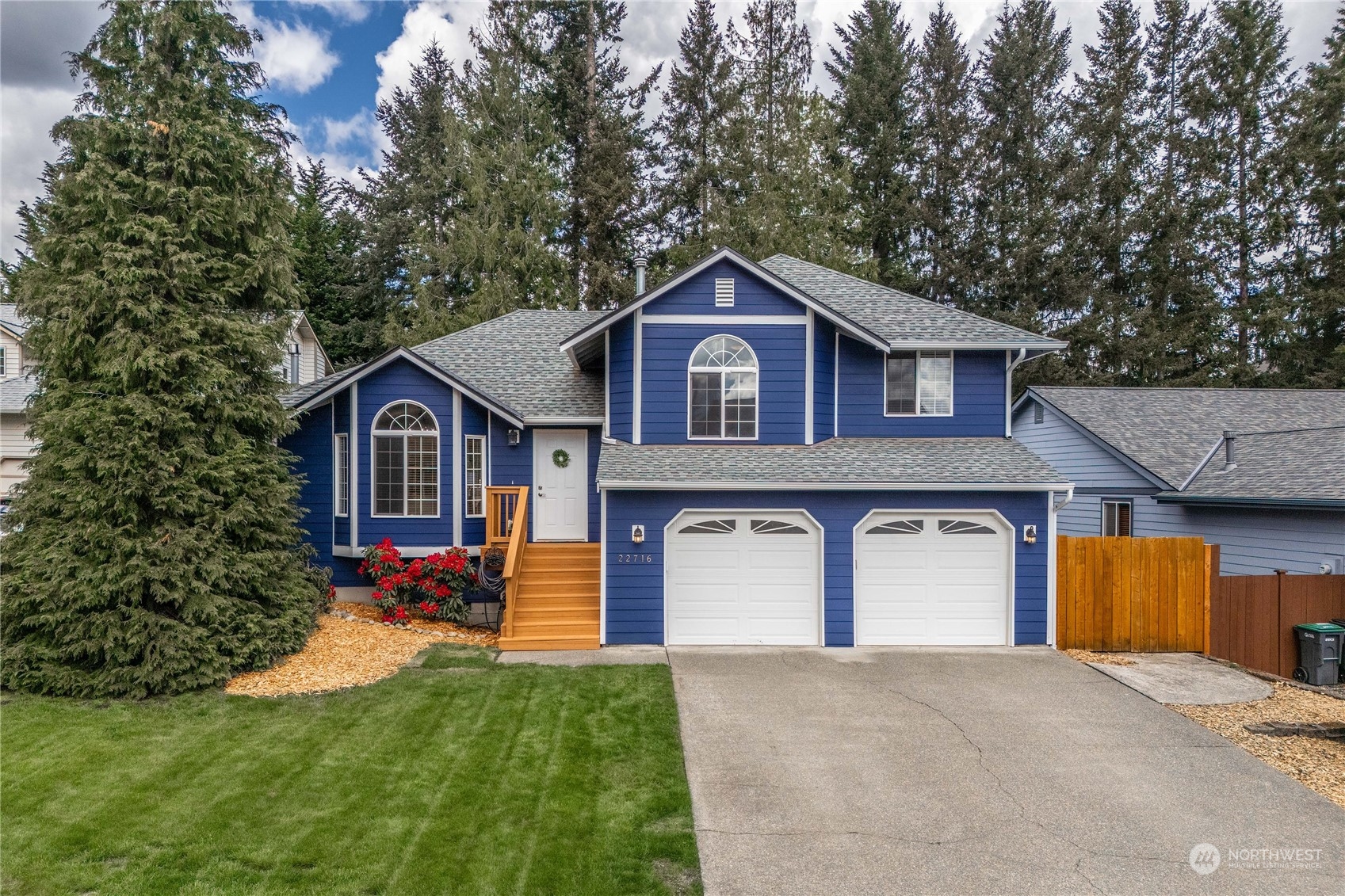 22716 Southeast 264th Place Maple Valley, WA 98038 - Photo 1 of 28 a front view of a house with a yard