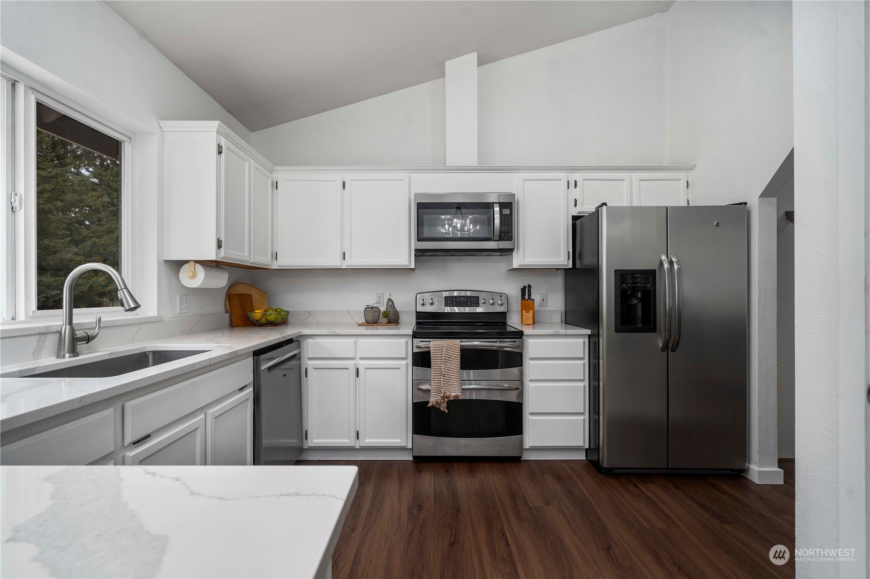 22716 Southeast 264th Place Maple Valley, WA 98038 - Photo 11 of 28 a kitchen with a sink cabinets stainless steel appliances and a window