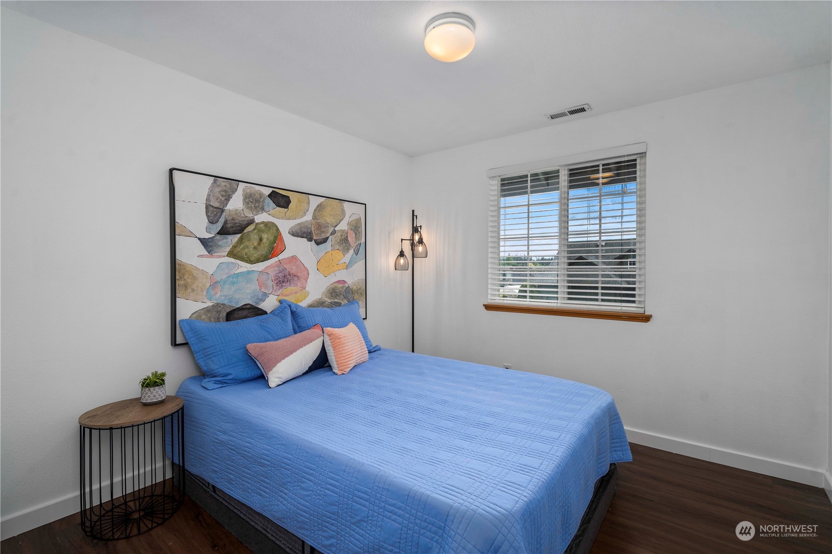 22716 Southeast 264th Place Maple Valley, WA 98038 - Photo 19 of 28 a bedroom with a bed and painting on the wall