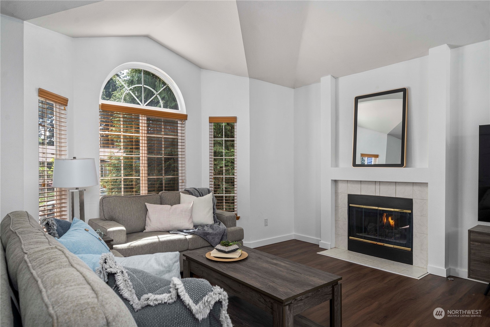 22716 Southeast 264th Place Maple Valley, WA 98038 - Photo 3 of 28 a living room with furniture a window and a fireplace