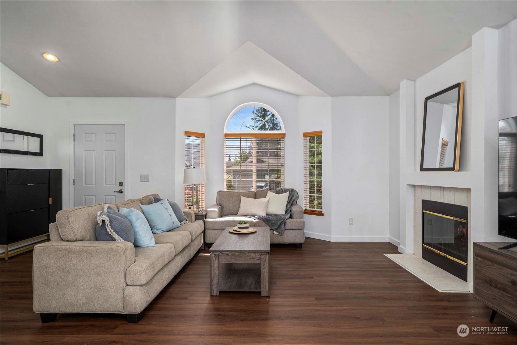 22716 Southeast 264th Place Maple Valley, WA 98038 - Photo 4 of 28 a living room with furniture or chandelier and a fireplace