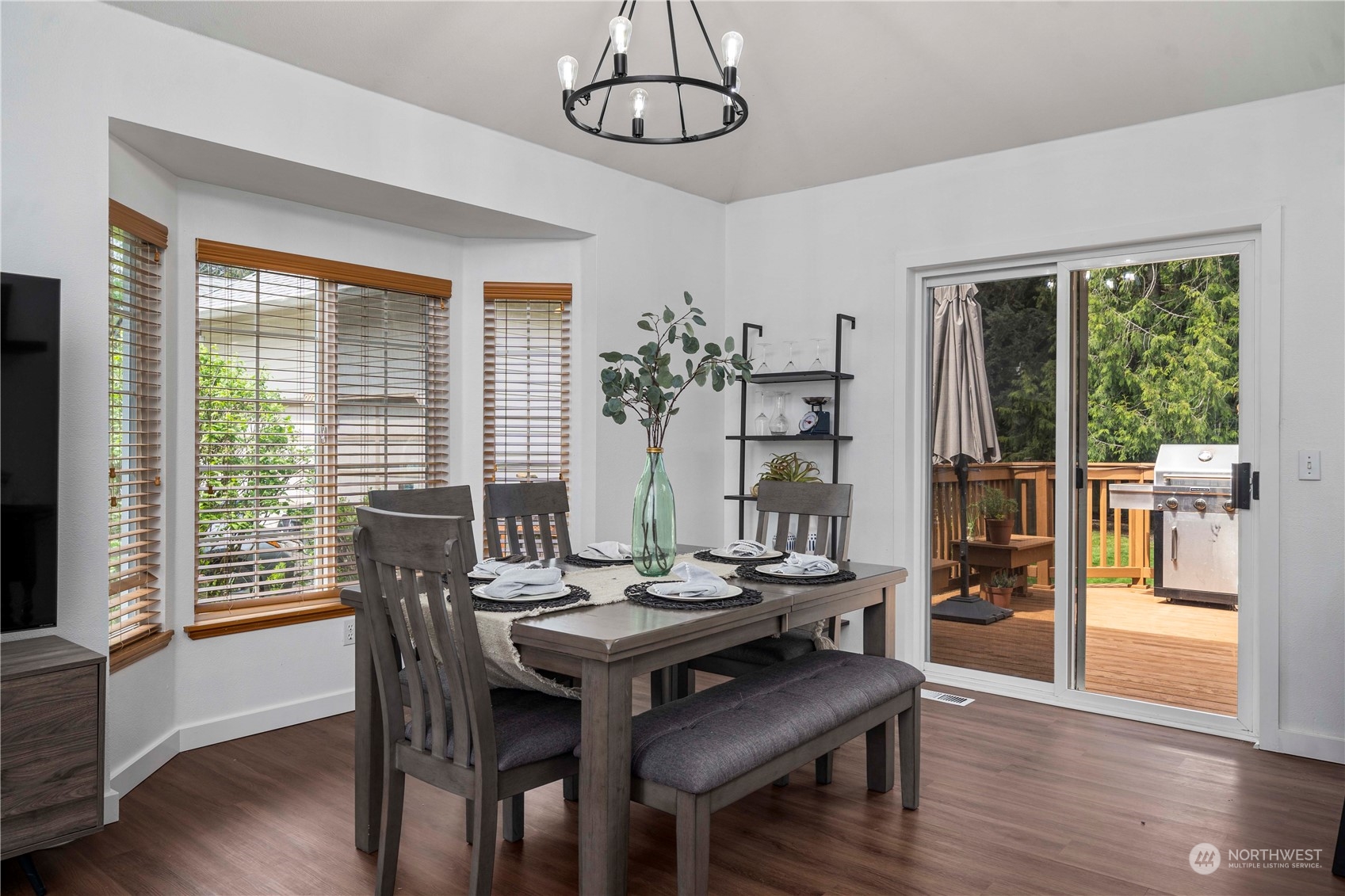 22716 Southeast 264th Place Maple Valley, WA 98038 - Photo 8 of 28 a view of a dining room with furniture wooden floor and chandelier