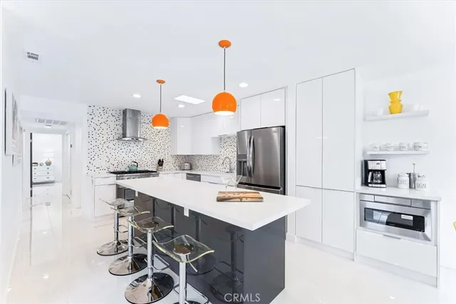 a kitchen with a sink cabinets and appliances
