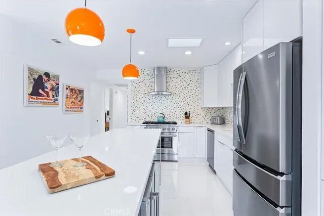 a kitchen with stainless steel appliances granite countertop a refrigerator and a sink