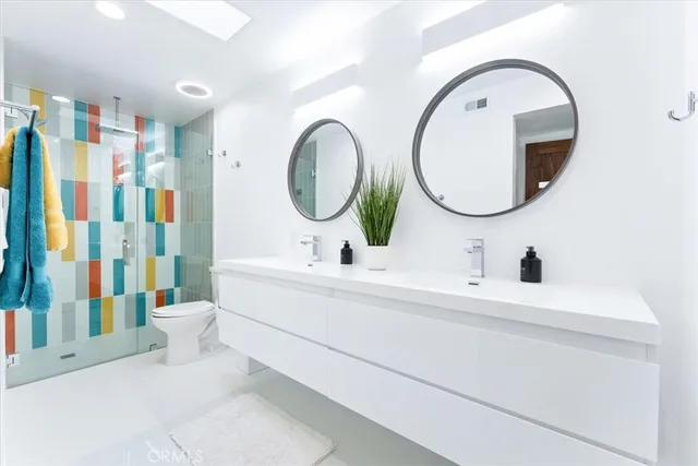 a bathroom with a double vanity sink and a mirror