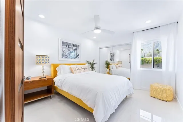 a spacious bedroom with a bed and a window