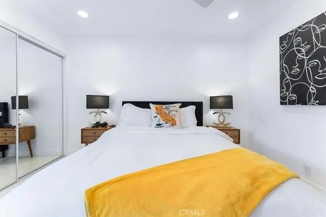 a bed room with a bed and a chair