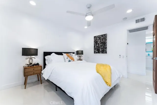 a bed room with a bed and a chair