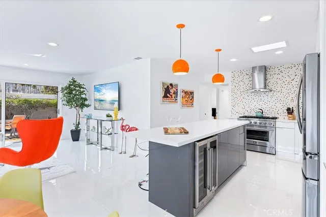 a kitchen with stainless steel appliances granite countertop a sink and a refrigerator