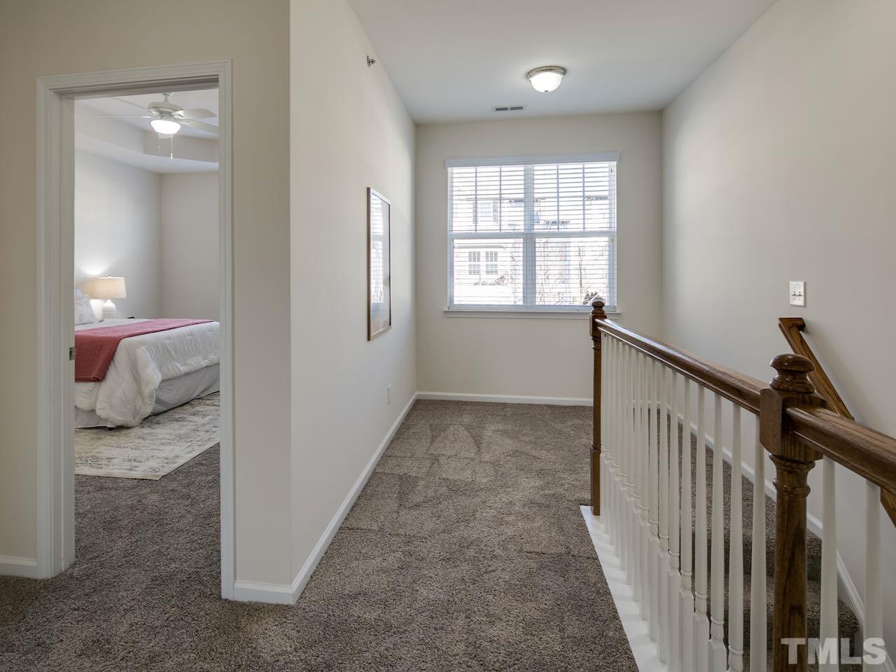 9133 Wooden Road Raleigh, NC 27617 - Photo 14 of 26 Upstairs there is an abundance of natural light due to the nine foot ceilings and the large open space between the three bedrooms.