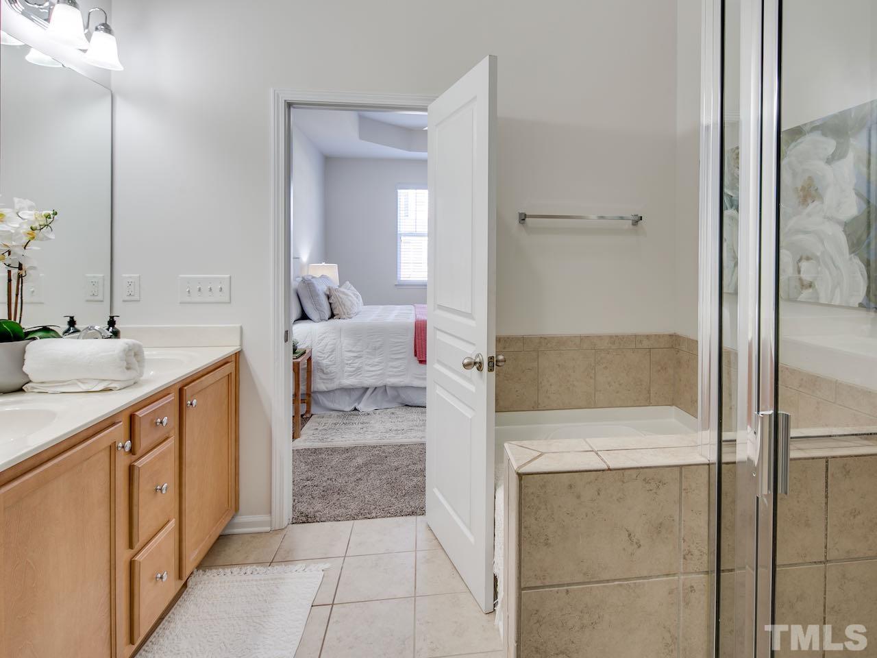 9133 Wooden Road Raleigh, NC 27617 - Photo 17 of 26 There are two full bathrooms upstairs and a half bathroom downstairs. This bathroom has a garden tub and separate shower.