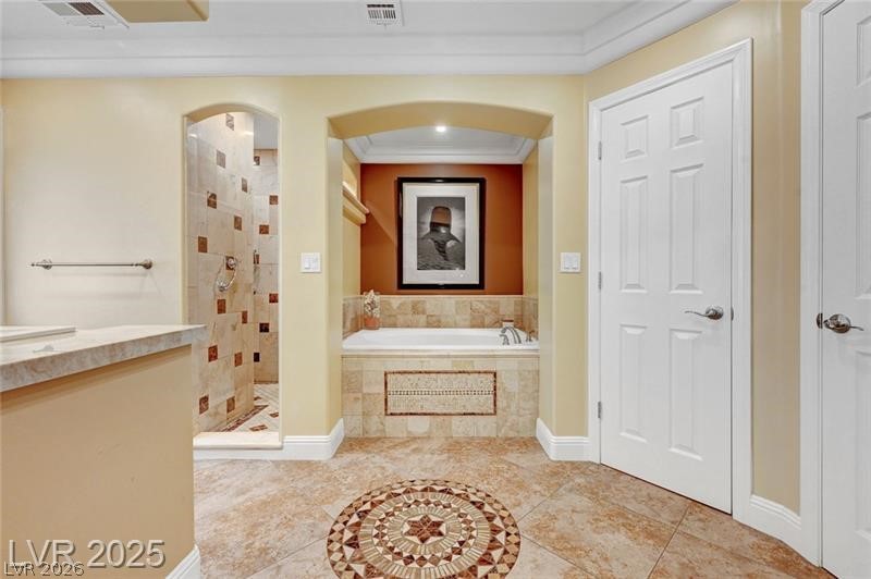 2410 Doherty Way Henderson, NV 89014 - Photo 42 of 63 Full bathroom with a garden tub, tiled shower, crown molding, tile patterned floors, and baseboards