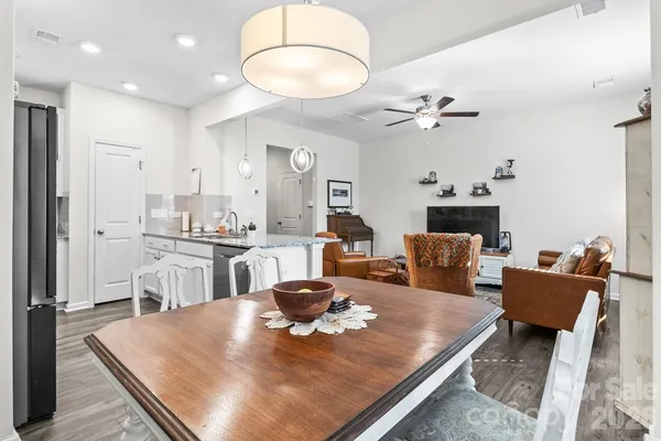 a living room with kitchen island furniture and a fireplace