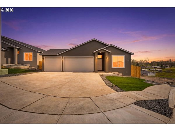 1758 Northeast 9th Street Hermiston, OR 97838 - Photo 1 of 23 a front view of a house with a yard and garage