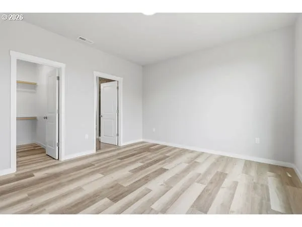a view of an empty room and wooden floor
