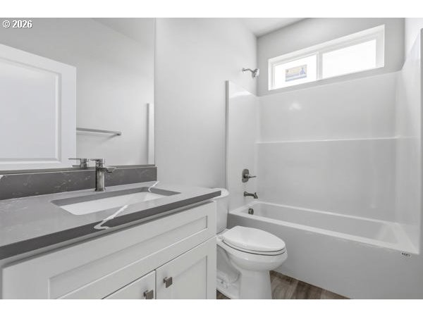 1758 Northeast 9th Street Hermiston, OR 97838 - Photo 15 of 23 a bathroom with a granite countertop toilet a sink and a bathtub