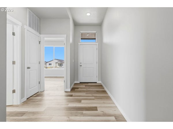 1758 Northeast 9th Street Hermiston, OR 97838 - Photo 4 of 23 a view of a hallway with wooden floor and staircase