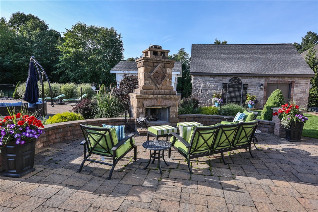 160 Goshawk Drive Victor, NY 14564 - Photo 43 of 50 VIEW OF THE OUTDOOR FIREPLACE ON THE EXPANSIVE BAC
