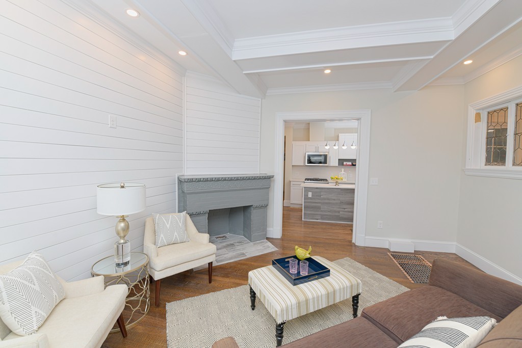 232 Aspinwall Avenue, Unit 1 Brookline, MA 02445 - Photo 3 of 13 a living room with furniture and a fireplace