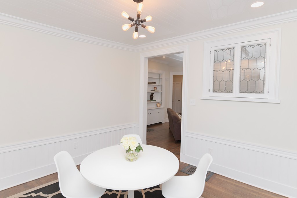232 Aspinwall Avenue, Unit 1 Brookline, MA 02445 - Photo 7 of 13 a view of a dining room with furniture and wooden floor