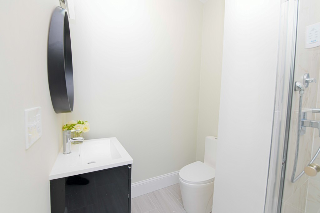 232 Aspinwall Avenue, Unit 1 Brookline, MA 02445 - Photo 9 of 13 a bathroom with a sink and a toilet