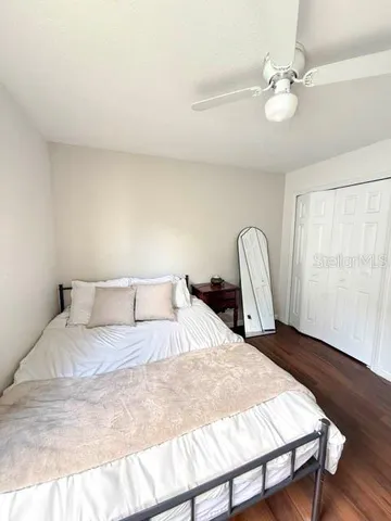 a large bed sitting in a bedroom next to a window